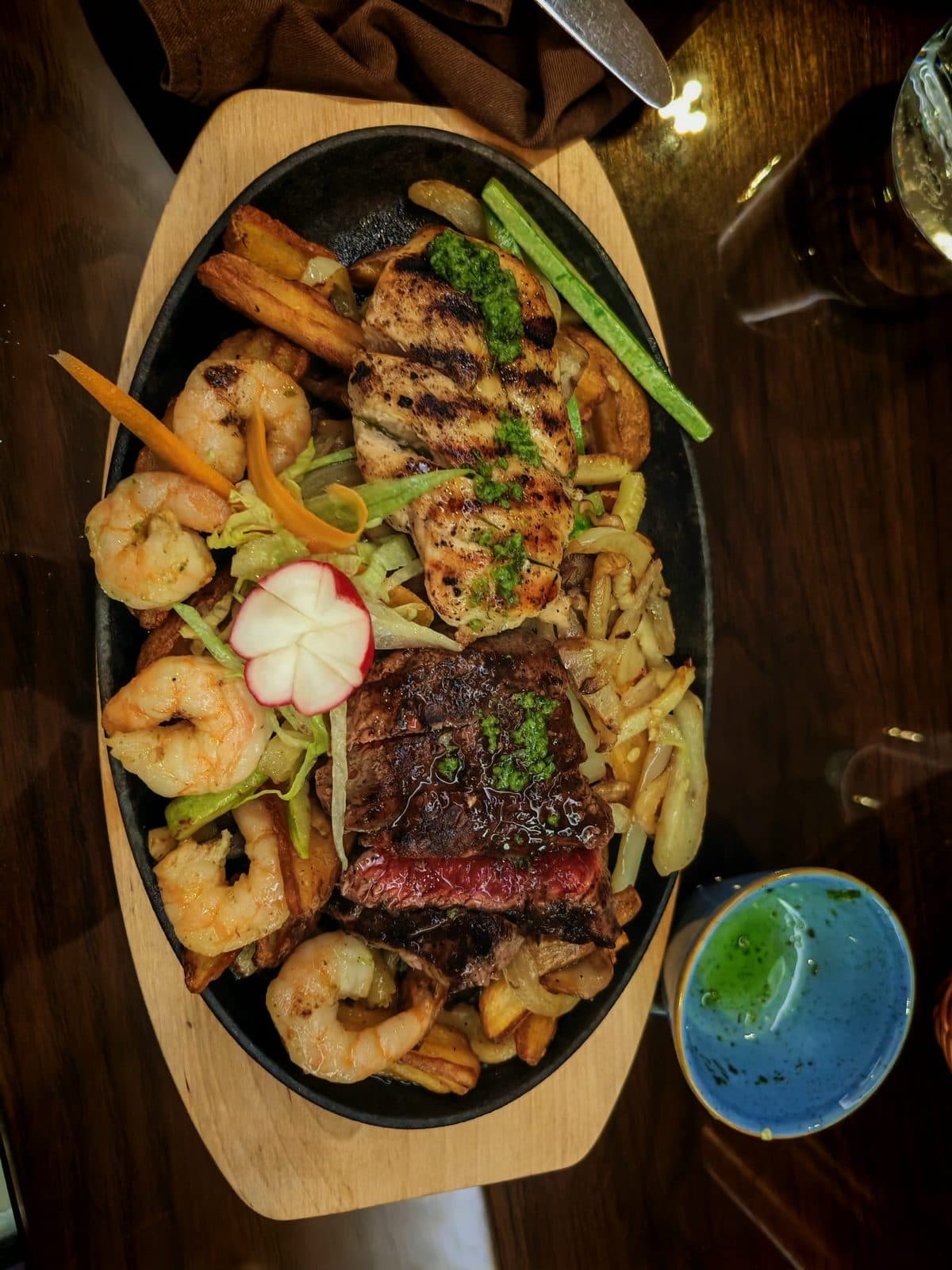 Grilled halal platter of meat and sides on a wooden board in Bosnia