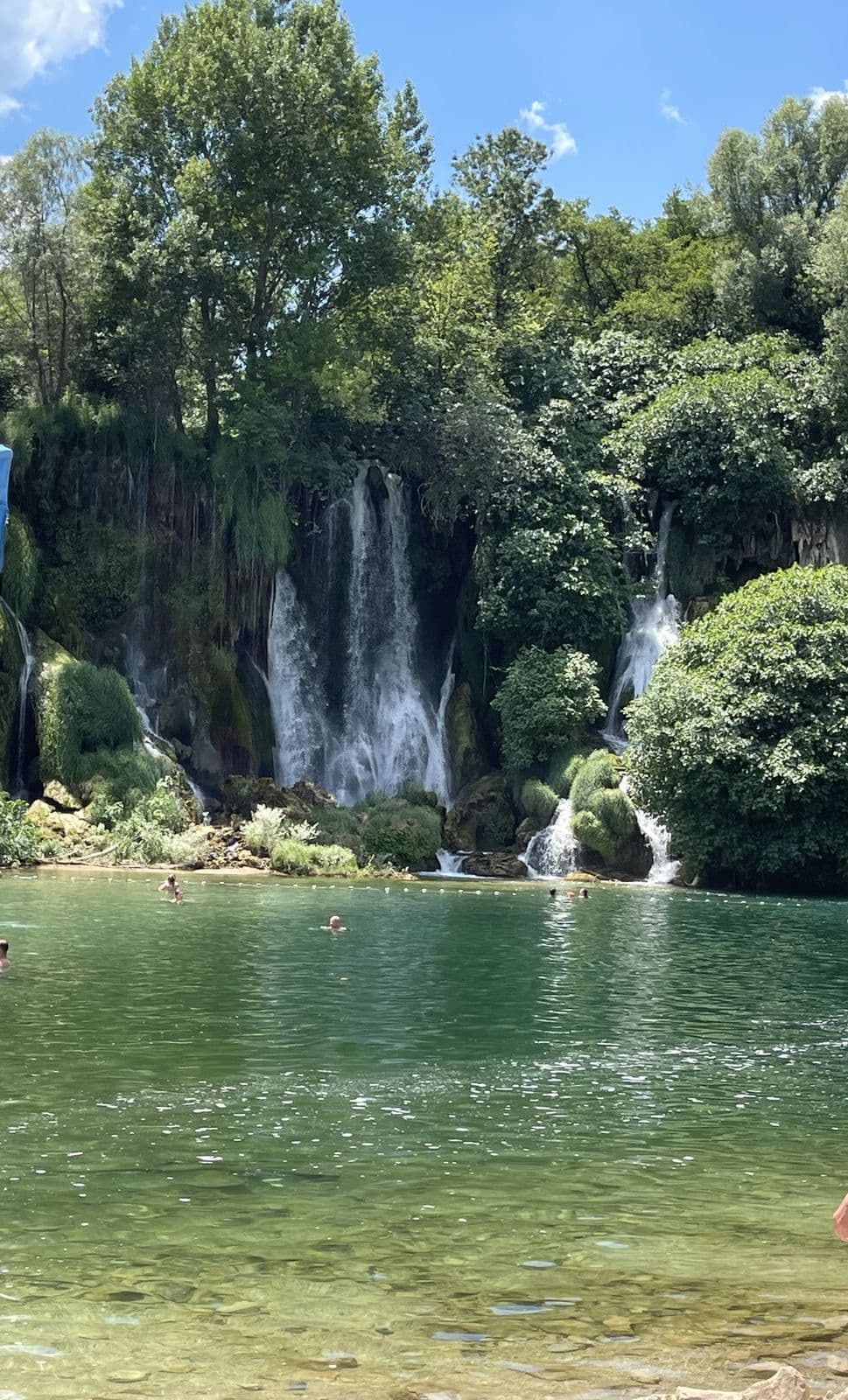 Swimmers enjoying the Kravice waterfalls pool
