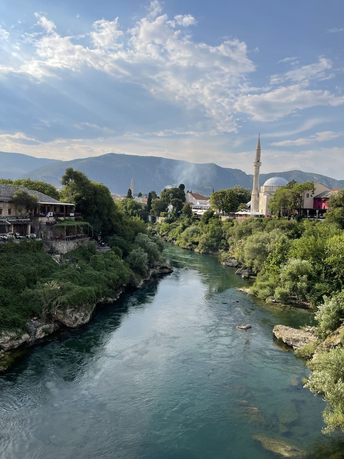 Minaret rising over an Ottoman town and emerald river in Bosnia & Herzegovina
